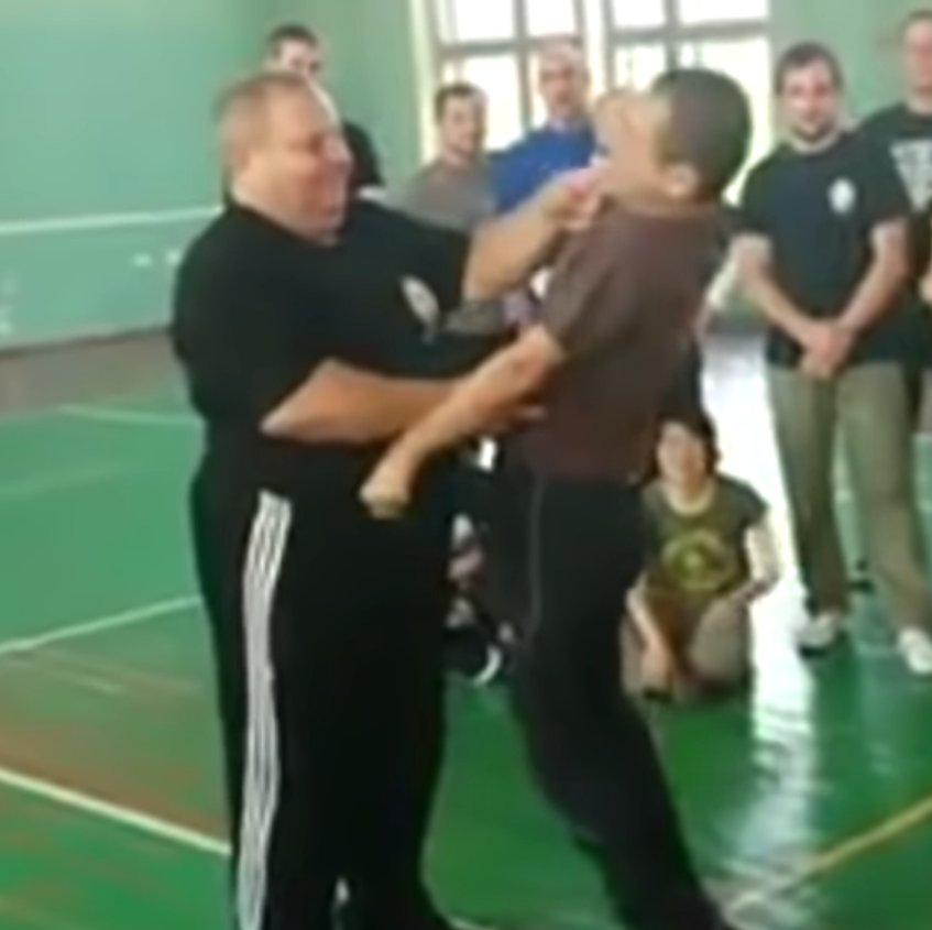 Portly Systema instructor pokes at more pressure points on training partner.